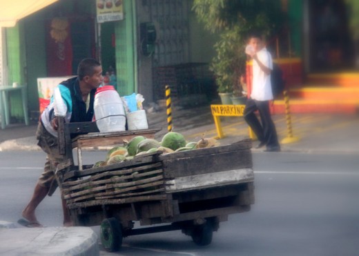 vendor pushing his cart with fresh buco juice