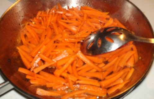 Julienned carrots sautéing.