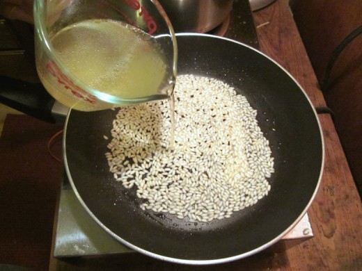 Adding broth to the rice &ndash; photo by timorous.
