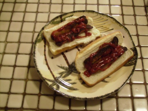 Currywurst on a bun with catchup and ready to eat. Currywurst on a bun with catchup and ready to eat.