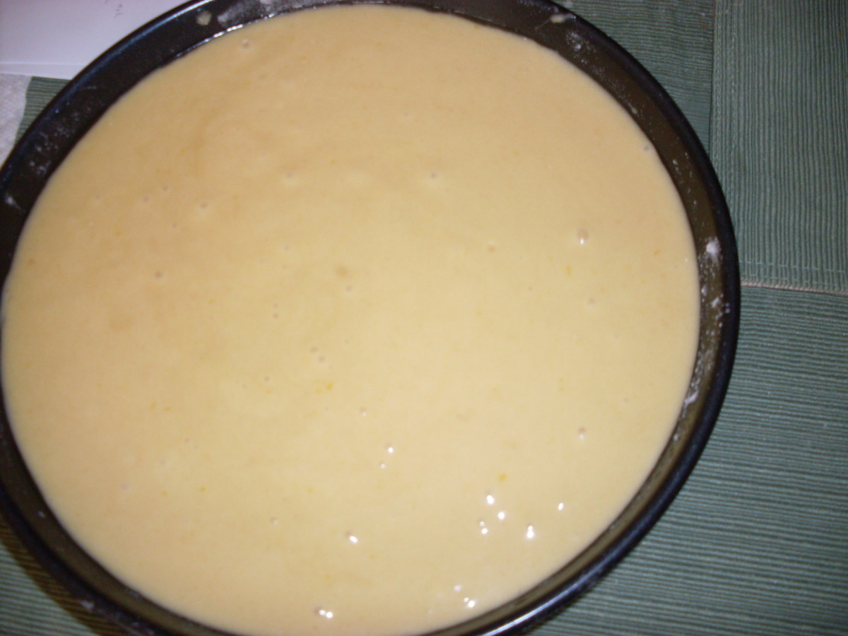 cheesecake batter in cake pan prepping for the oven