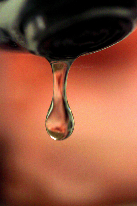 a water drop about to exit from the faucet