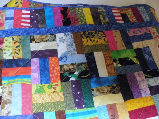 This rail fence quilt is a scrap quilt that uses any and all fabrics.