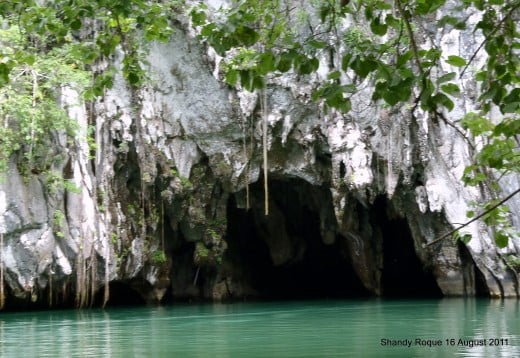 The entrance to the Puerto Princesa Subterranean River. With the beautiful contrast of the turquoise brackish water and the white limestone facade of the cave framed by the vines and moss hanging in front of the cave, this could be a lovely subject.