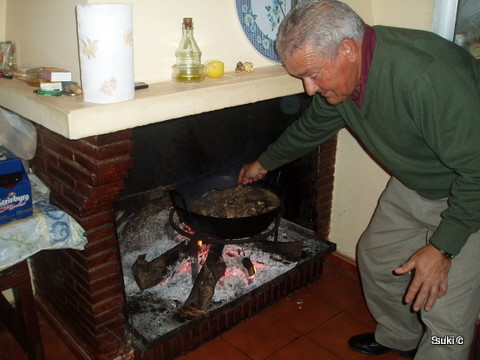 Our neighbour cooking Christmas lunch in the traditional way over an open fire.
