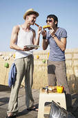 THESE GUYS ARE HAVING A GREAT TIME ENJOYING BURGERS AT A BARBECUE. YOU CAN TOO WITH MY RECIPE FOR 'HOBO HAMBURGERS.'