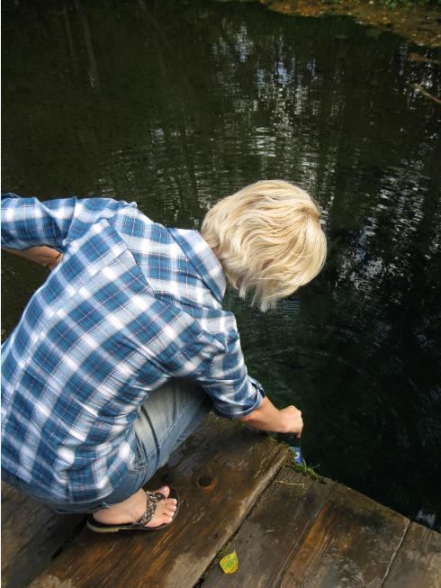 My wife gathering water from sacred spring.  (Photo taken in vicinity of Valday District in Novgorod Oblast, Russia).