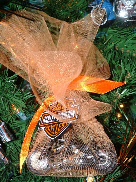 Some Harley Davidson models are wrapped in bright orange toile and ribbons. 