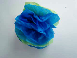 Fluff out the tissue for forming a paper flower.