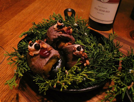 Persimmon-stuffed bison topped with walnut pudding, cranberry purée, puffed barley and juniper berry skins. The bison is served sizzling, on hot river rocks, surrounded by fresh juniper branches in a cast iron skillet.
