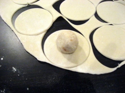Ball of potato filling on one of the dough circles