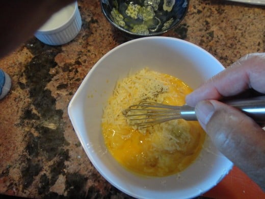 Whisking together the eggs, Ricotta, oregano, and the Romano cheese