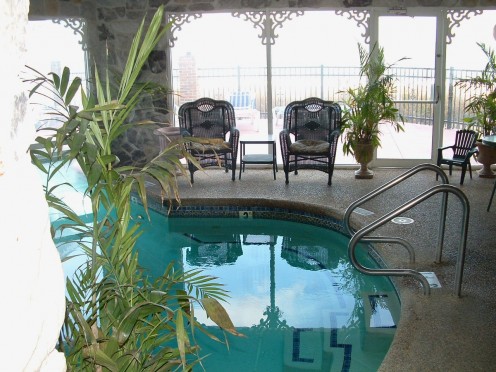 Heated Indoor spa pool with view of outside pool, deck and ocean. The spa pool is reserved for adults only in the evenings. Guests of any age may use it in the daytime.