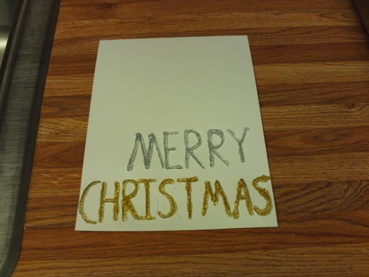 Here I finished tracing over the word "Christmas" with the silver glitter glue.