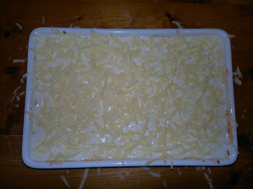 Assemble the lasagne and top with the cheese.