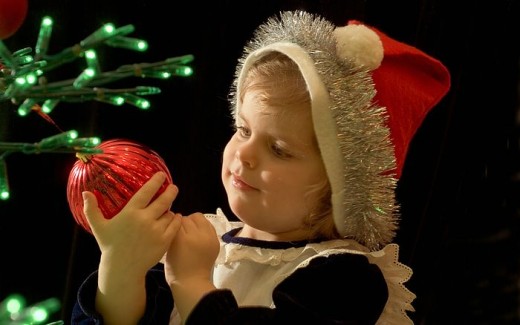 Boy decorating Christmas tree, Santa hat