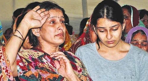 Example of News Photograph. The mother of a martyr saluting her only son on his funeral.