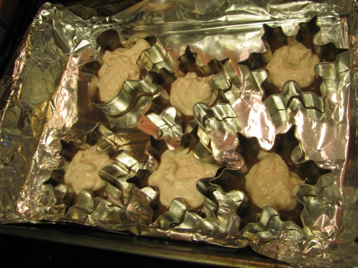 Step 7: spoon the white chocolate peppermint into the cookie cutters on top of the dark chocolate.