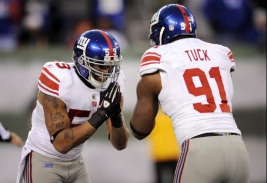 New York Giants' Michael Boley, left, and Justin Tuck celebrate a sack by Tuck during the fourth quarter of an NFL football game against New York Jets, Saturday, Dec. 24, 2011, in East Rutherford, N.J. The Giants won 29-14. (AP Photo/Bill Kostroun)
