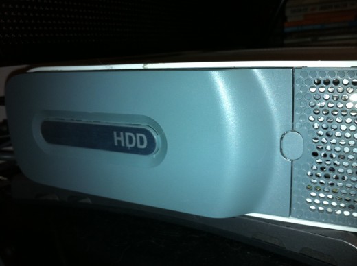 The button you press to release the hard drive is located between the hard drive and a vent.