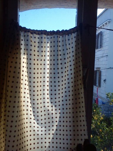 On the right window pane you can see the shoelace which holds the right curtain up.  It took a few minutes to hang them.