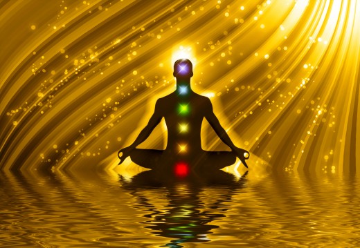Meditating silhouette depicting the 7 energy centers (chakras)