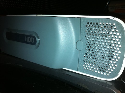 The hard drive is located along the left edge of the Xbox 360. A damaged or defective hard drive could result in a red light error.