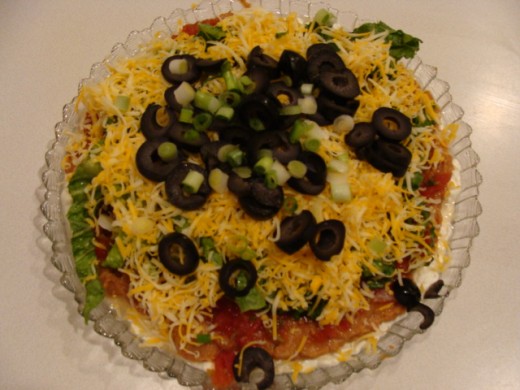 Add the additional toppings like the black olives and green onion.
