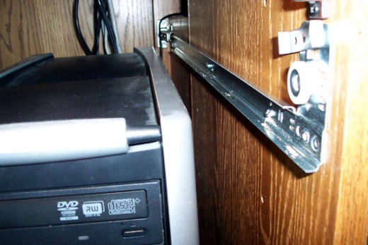 The upper guide on the right side was just below the edge of the CPU, so I had to pull it out of the way in order to screw in the rails. The shelf guides roll on the wheels above the rail.