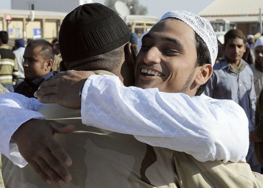 Aamir, a Muslim worshipper, hugs U.S. Navy Petty Officer 3rd Class Phrshin Jackson, assigned to the NATO Role 3 Multinational Medical Unit, after the prayer service of Eid al-Adha at Kandahar Airfield, Afghanistan, Nov. 16. 