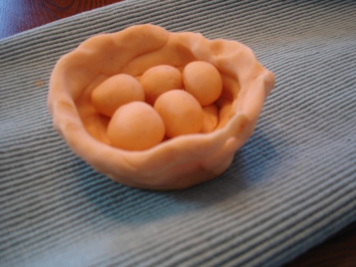 Play dough eggs in a nest. 