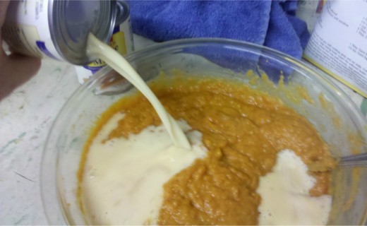 Slowly stir evaporated milk into pumpkin mixture