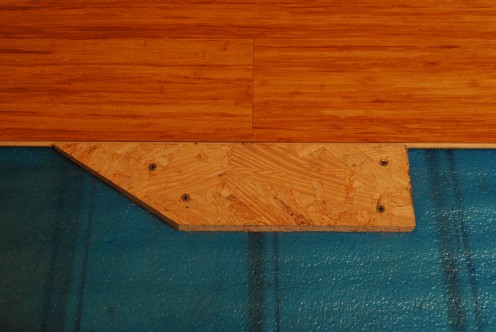 Scrap wood or scrap pieces of flooring works well as blocking. Be sure to secure the seams since they are the weak point while hammering.