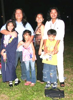 My son and his children, the eldest girl and the boy-girl twins; this picture was taken when they were still living near my home in 2004. Beside me is my daughter when she was still single.