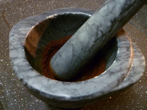 Mortar & Pestle with Fresh Ground Coffee Beans.