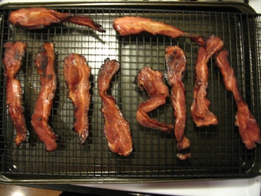 Place a cooling rack over a baking sheet to cook bacon in the oven. Bake at 350 F until the desired crispness is reached.