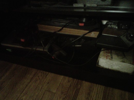 One of my 2600s, another Odyssey 2, a 5200, and a couple of Pong Clones lurk under there.  I have a Pong that I have to resolder/replace the potentiometers on before it works 100%.