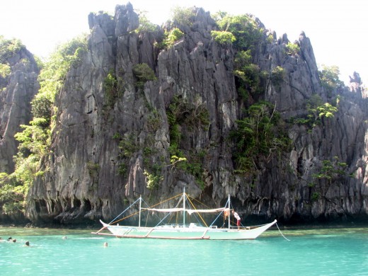 Our boat for the island hopping tour of Tour A waits for us while we snorkel by the lagoons