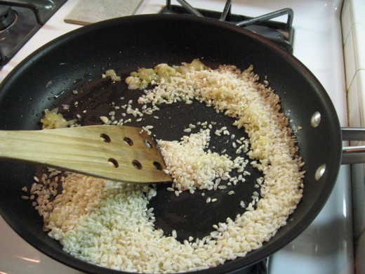 Brown rice (about 1 cup) in olive oil. Add more olive oil if necessary to insure each kernel of rice is coated and lightly browned. 