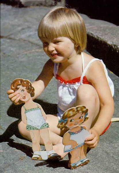Little girl playing with paper dolls, always fun they could provide hours of imaginative play!
