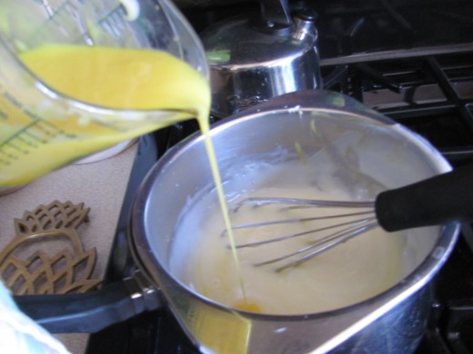 adding yolks to pudding mixture