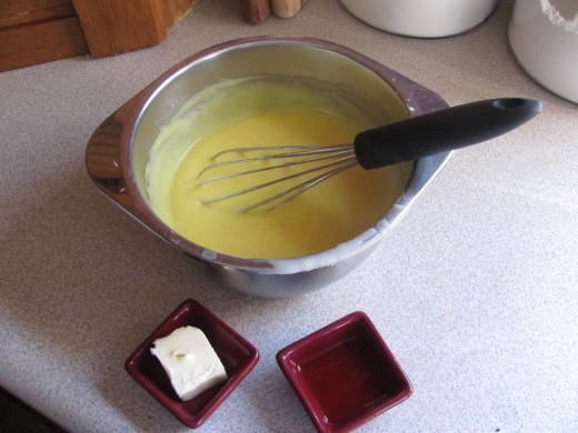 adding butter and vanilla to pudding mixture