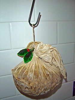 Christmas pudding drying out on hook in order to enhance the flavour. This pudding has been prepared with a traditional cloth rather than a basin.