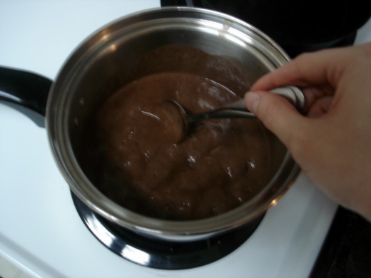 Cooking the chocolate frosting.