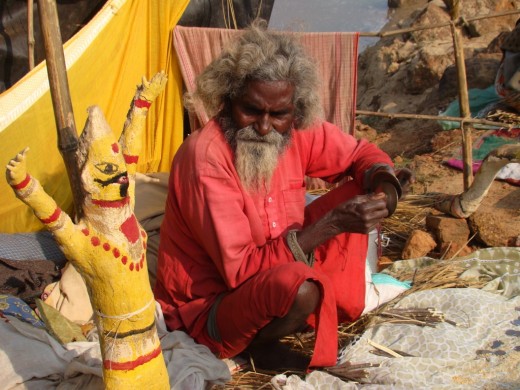 A sadhu with an idol --- a tool for begging!