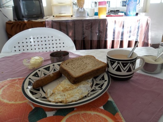 Sausage, egg, toast and hot tea. You can choose to have coffee or milo. 
