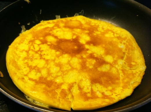Once the edges of the eggs become cooked, flip it over before adding any fillings.