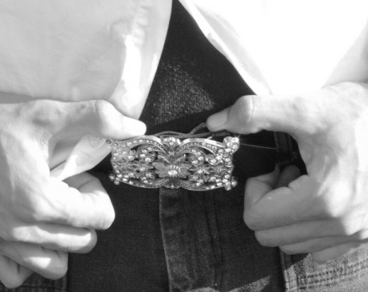 Avoid big or shiny belt buckles like these as they draw a clear line between the upper and lower body.