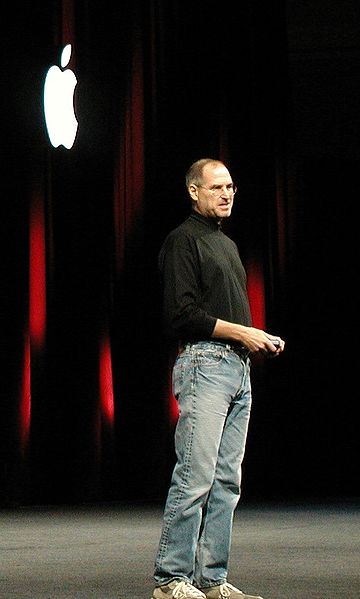 Steve Jobs dressed in his trademark black mock turtle neck and jeans.