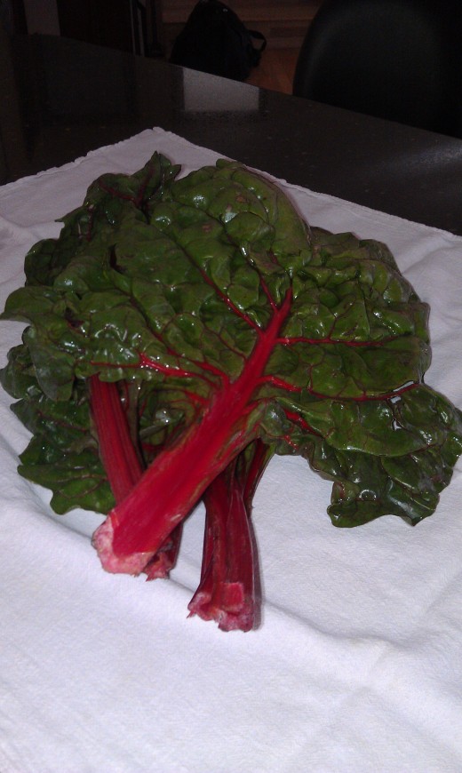 Lay the kale or swiss chard in a clean tea towel. The leaves can still have water clinging to it.